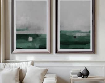 May include: Two framed abstract art prints. Each print features a landscape-style design with a gradient of gray and green hues. The artwork is encased in a silver frame, adding a touch of elegance to the wall decor.