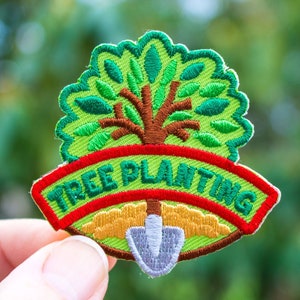 May include: Green embroidered patch with a tree and a shovel, with the text "TREE PLANTING" in a red and green banner.