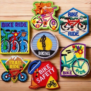 May include: Seven colorful embroidered patches featuring bicycles and the words "Bike Ride", "Trail Ride", "Bike Safety", "Biking", and "Bike Rider".