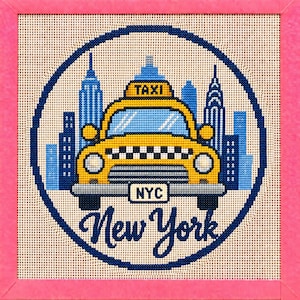 May include: A needlepoint embroidery featuring a yellow taxi cab with a checkered grille and a sign reading TAXI. The car is centered against a blue New York City skyline silhouette. The text NYC and New York are stitched below. Framed in pink.