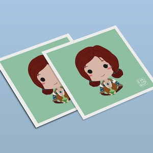 May include: Two printed cards with a green background and a cartoon illustration of a woman with red hair holding a small green creature. The woman is wearing a brown and blue outfit with a blue necklace.
