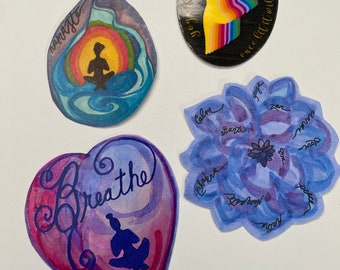 May include: Four watercolor stickers with inspirational messages and designs. The first sticker is a blue teardrop shape with a silhouette of a person meditating and the words "namaste". The second sticker is a black circle with a rainbow design and the words "yoga is light" and "once lit it will never dim". The third sticker is a purple heart shape with the word "breathe" and a silhouette of a person meditating. The fourth sticker is a blue flower shape with the words "calm", "shanti", "zen", "love", "peace", "asara", "breathe", and "soul".