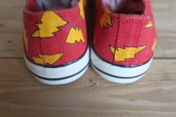 red shoes with lightning bolt