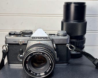 Olympus OM-2 Silver 35mm SLR Camera w/50mm & 75-150mm Olympus lenses working