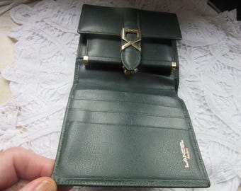 May include: A dark green leather wallet with a gold clasp and the text "Lancel Paris" on the front.