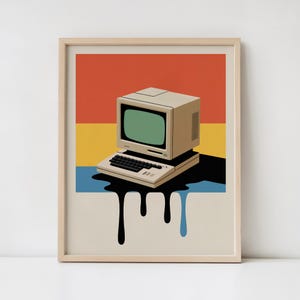 May include: Framed art print featuring a vintage computer with a green screen and keyboard. The background has horizontal bands of red, yellow, and blue. Black drips extend from the computer, creating a unique visual effect. The print is in a wooden frame.