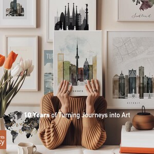 a woman sitting in front of a bunch of pictures