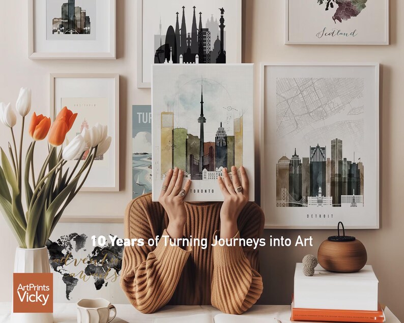 a woman sitting in front of a bunch of pictures