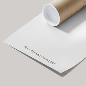 A roll of white matte paper with the text "Fine Art Matte Paper" printed on it, placed on a plain white surface.