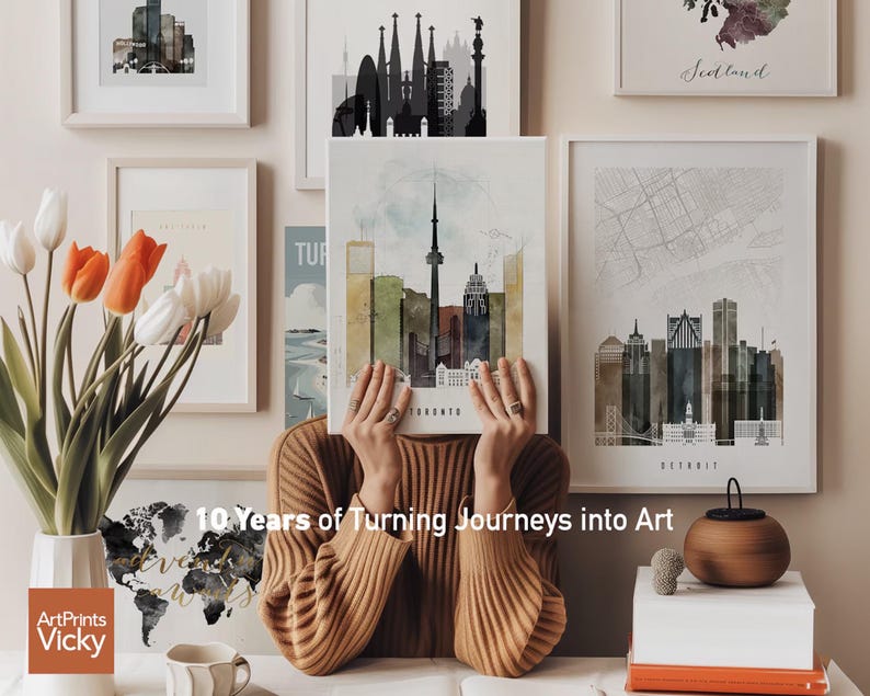 a woman sitting in front of a bunch of pictures