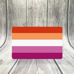 May include: A lesbian pride flag with six horizontal stripes in the colors red, orange, white, pink, light purple, and dark purple.