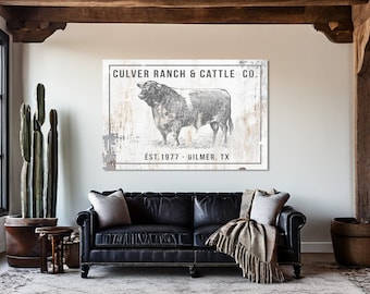 May include: A black and white canvas sign with a vintage aesthetic. The sign features a drawing of a bull and the text "CULVER RANCH & CATTLE CO. EST. 1977 - GILMER, TX". The sign is framed with a distressed wood border.