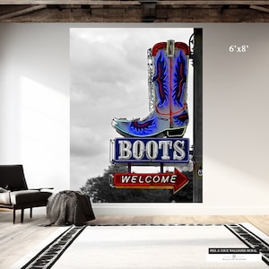 May include: A neon sign in the shape of a cowboy boot, with blue and red lights, sits atop a sign that reads "BOOTS" and "WELCOME". The background is a black and white image of a cloudy sky.