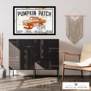 May include: A vintage-style sign with the text "Pumpkin Patch" in black lettering on a white background. A red pickup truck with a white bed is driving through a field of pumpkins. The sign also includes the text "Hayrides, Pumpkins, Candy Apples, Corn Maze".