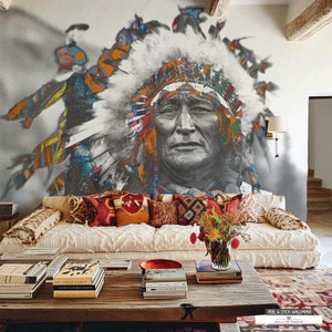 May include: A colorful mural of a Native American man wearing a headdress, with a white couch and a wooden coffee table in the foreground. The mural is painted in shades of blue, green, orange, and red.