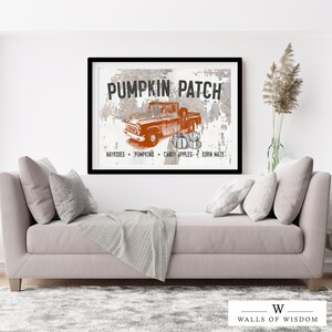 May include: A vintage-style sign with the text "Pumpkin Patch" in black lettering on a white background. The sign features a red pickup truck with pumpkins in the bed, and the text "Hayrides, Pumpkins, Candy Apples, Corn Maze" at the bottom.