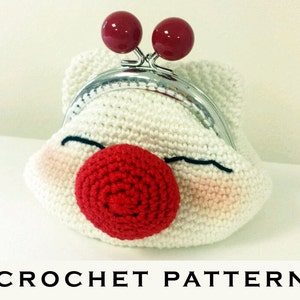 May include: White crocheted coin purse with a red nose and two red buttons on top. The purse has a black embroidered mouth.