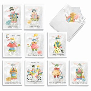 May include: A set of ten greeting cards featuring watercolor illustrations of rabbits in colorful clothing with Easter themes. Each card displays unique text including Spring Welcome, Easter Greetings, Hoppy Easter, Have a Sunny Spring, Spring Has Sprung, Spring Greetings To You, Bunny Kisses and Easter Wishes, Have an Egg-cellent Easter, and You are Egg-stra Special.