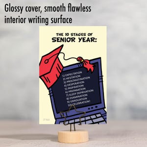 May include: A yellow card with a black and blue computer screen and a red graduation cap. The text on the card reads "The 10 Stages of Senior Year:" and lists the stages: Expectation, Hesitation, Procrastination, Desperation, Inspiration, Preparation, Sleep Deprivation, Examination, Graduation, Celebration!