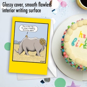 May include: A yellow greeting card with a cartoon illustration of a rhinoceros with a group of birds on its back. The card reads "This is the life - I'm never travelling Economy again!" and is signed "whyatt".