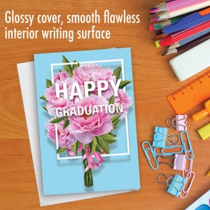 May include: A light blue card with a white border and the text "HAPPY GRADUATION" in white letters. The card features a bouquet of pink peonies with green leaves.