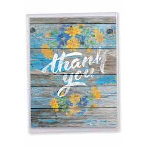 May include: A rectangular greeting card featuring a weathered blue and brown wood plank background. The card displays a painted floral wreath of yellow and blue flowers surrounding the white hand-lettered text that reads thank you.