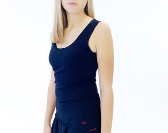 May include: A black tank top with a scoop neck and a black skirt with a ruffle detail. The top has a small red logo on the front.