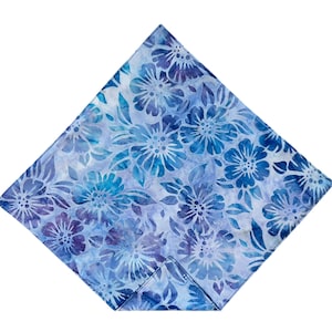 May include: A blue and white floral patterned fabric square.