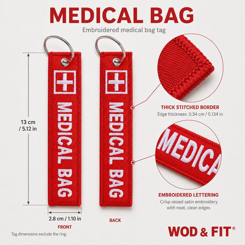 May include: Two rectangular red fabric medical bag tags with white embroidered text reading MEDICAL BAG and a white cross symbol. Each tag measures 5.12 inches by 1.10 inches and features a silver metal keyring, thick stitched borders, and raised satin embroidery.