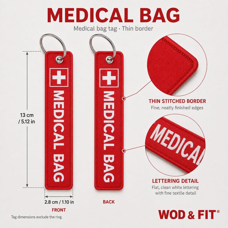 May include: A rectangular red fabric medical bag tag with a white cross icon and the text MEDICAL BAG in white. The tag measures 5.12 inches by 1.10 inches, excluding the metal keyring. It features a thin stitched border and clean white lettering.