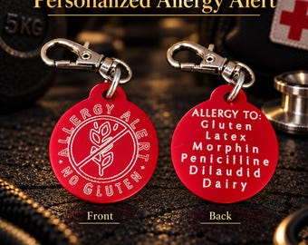 May include: Two round red metal allergy alert tags with silver lobster claw clasps. The front features a wheat icon with a strike-through and the text ALLERGY ALERT NO GLUTEN. The back lists the text ALLERGY TO: Gluten, Latex, Morphin, Penicilliine, Dilaudid, Dairy.
