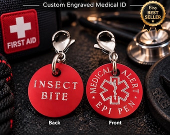 May include: Two circular red medical alert tags with silver lobster claw clasps. The front tag features a white Star of Life symbol with the text MEDICAL ALERT and EPI PEN. The back tag is engraved with the text INSECT BITE in silver lettering.