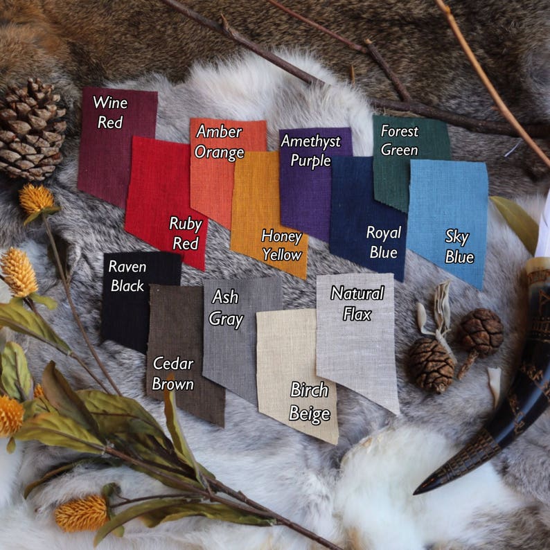May include: A collection of fabric swatches in various colors and textures, including wine red, amber orange, amethyst purple, forest green, ruby red, honey yellow, royal blue, sky blue, raven black, ash gray, natural flax, cedar brown, and birch beige.