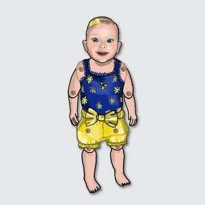 May include: A smiling baby doll wearing a blue and white floral print tank top with a yellow bow and matching yellow shorts.