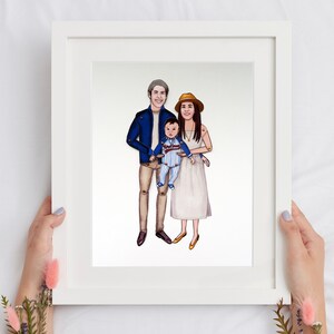 May include: A framed illustration of a family portrait. The family is depicted in a cartoon style with the father wearing a blue jacket, the mother wearing a white dress and a brown hat, and the child wearing a blue and white striped outfit.