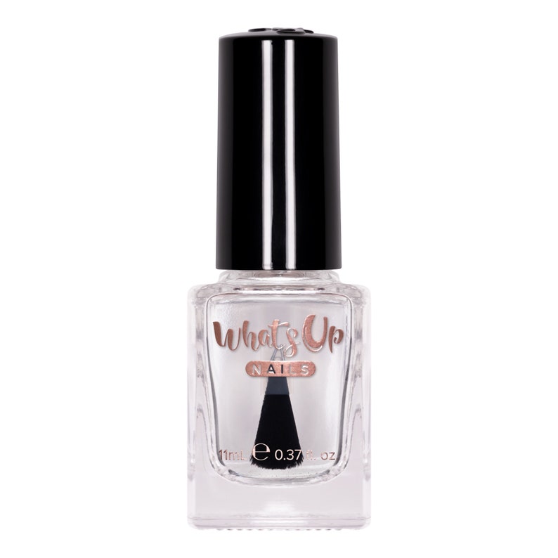 May include: A clear glass bottle of nail polish with a black cap. The bottle is labeled "What's Up Nails" in rose gold lettering. The bottle contains 11ml or 0.37 fl oz of polish.