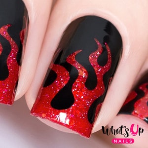 May include: Close-up of red and black nail art with a flame design. The nails are painted black with red glitter flames.