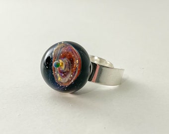 Space Glass ring mounted on a solid silver