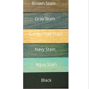May include: A wood sample board showing eight different wood stain colors: Early American, Brown, Gray, Golden Oak, Navy, Aqua, Black, and White.