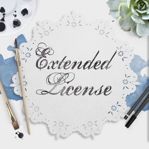 May include: A white doily with a black script font that reads "Extended License". The doily is surrounded by paintbrushes, a paint palette, and a succulent plant.