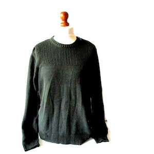 May include: A dark green long-sleeved sweater with a ribbed texture.