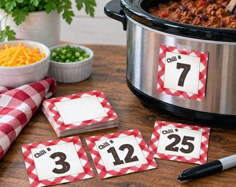 May include: A set of square paper labels with a red and white gingham border and a white centre. The labels feature the text Chili # followed by a number. One label is attached to a stainless steel slow cooker, while others show numbers 3, 12, and 25.