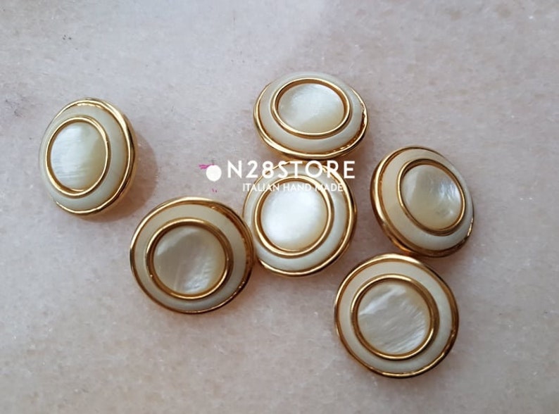 measuring 20 mm. Beautiful shank buttons available in gold and ivory mother-of-pearl