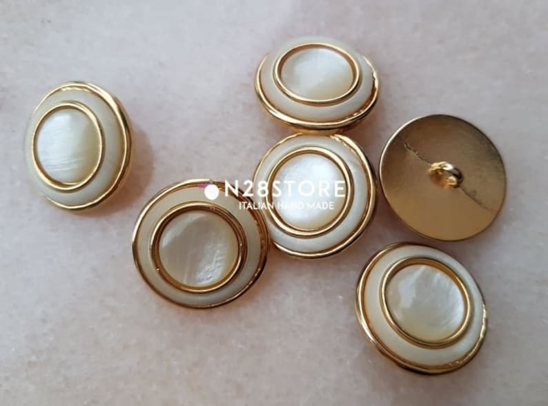 measuring 20 mm. Beautiful shank buttons available in gold and ivory mother-of-pearl