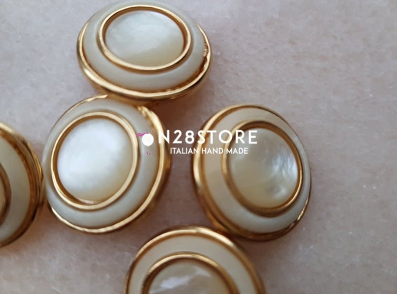 measuring 20 mm. Beautiful shank buttons available in gold and ivory mother-of-pearl