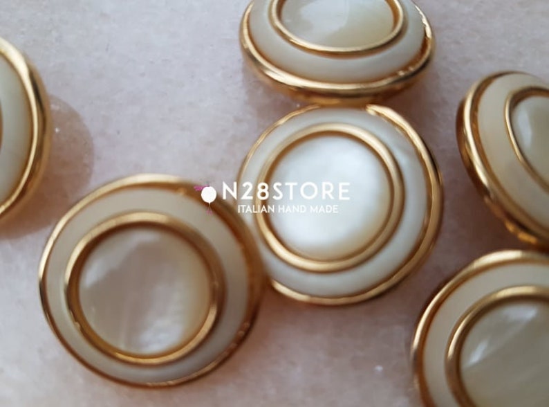 measuring 20 mm. Beautiful shank buttons available in gold and ivory mother-of-pearl