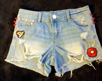 Upcycled clothing, thrifted clothing, denim shorts, studded shorts, patched shorts, short shorts, spiked shorts, cute gifts for her