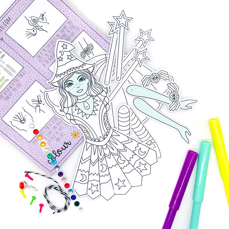 May include: A black and white paper craft kit featuring a witch with a star-shaped wand, a spider, and a crescent moon. The kit includes colorful gems, string, and push pins.