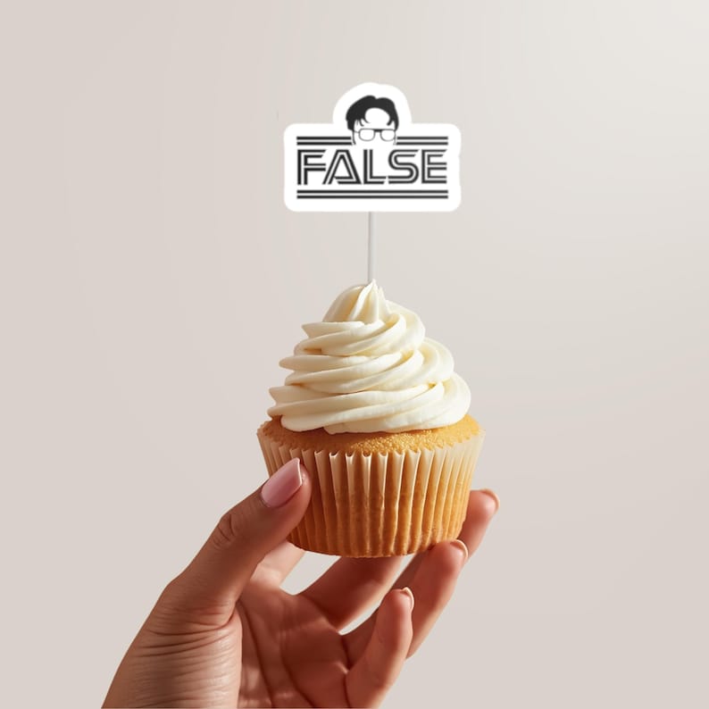 May include: A cupcake with white frosting, held by a hand. A white topper with the word "FALSE" in black, and a cartoon image of a person with glasses, is inserted into the cupcake.