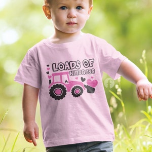 May include: Pink toddler t-shirt featuring a pink tractor carrying hearts and the text "Loads of Kindness".